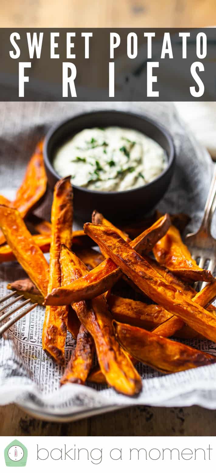 Baked sweet potato fries on a tray with a bowl of dipping sauce & a text overlay above that reads "Sweet Potato Fries."