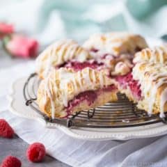 Raspberry Cream Scones with Rosewater Glaze: a fresh batch of scones, filled with raspberries and drizzled with glaze.