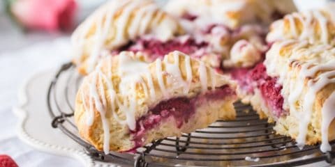 Raspberry Cream Scones with Rosewater Glaze: a fresh batch of scones, filled with raspberries and drizzled with glaze.