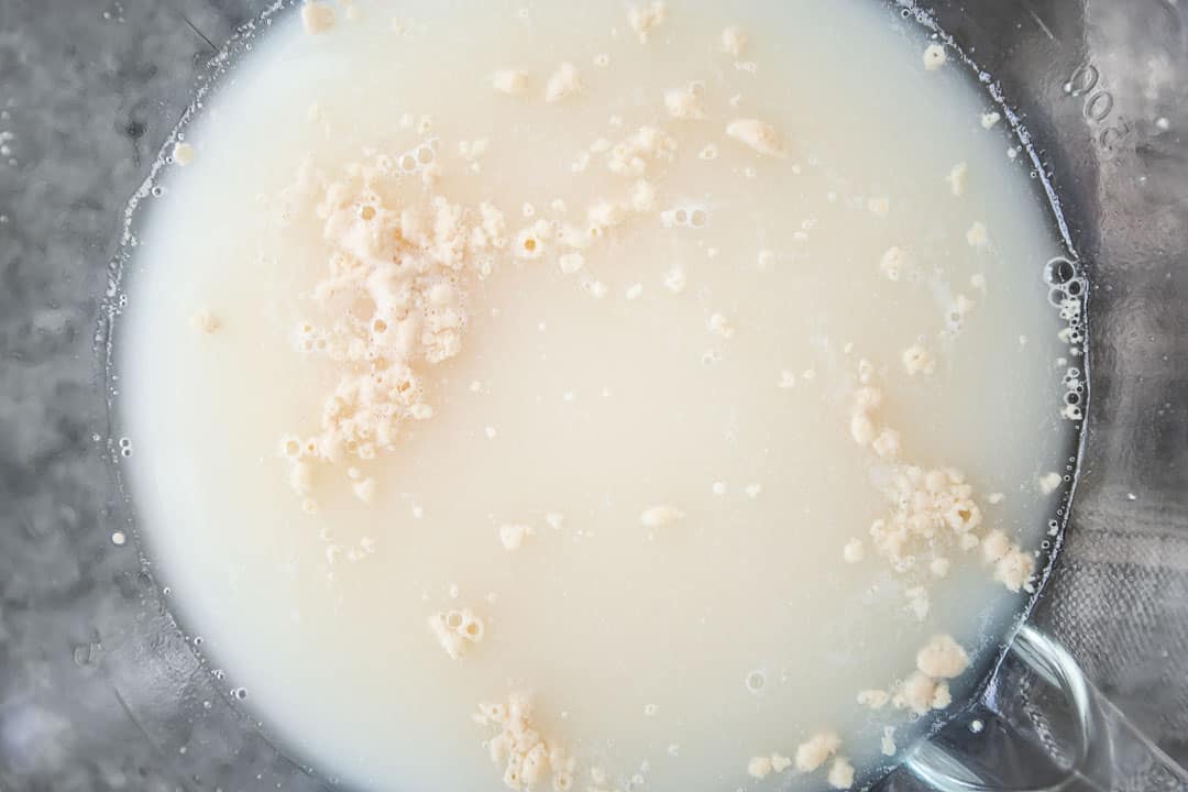 Proving yeast in warm water, close-up image of bubbles and foam.