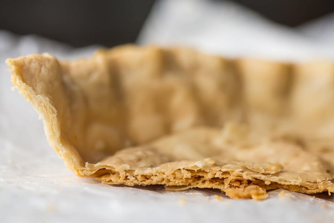 Close-up image of a flaky pie crust, showing many layers of crisp pastry.