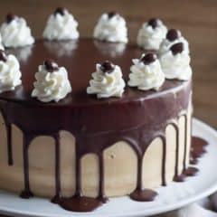 Alternating layers of Angel Food Cake and Devils Food Cake are filled with Salted Caramel Mousse, frosted with Espresso Swiss Meringue Buttercream, and glazed with a Decadent Dark Chocolate Ganache.