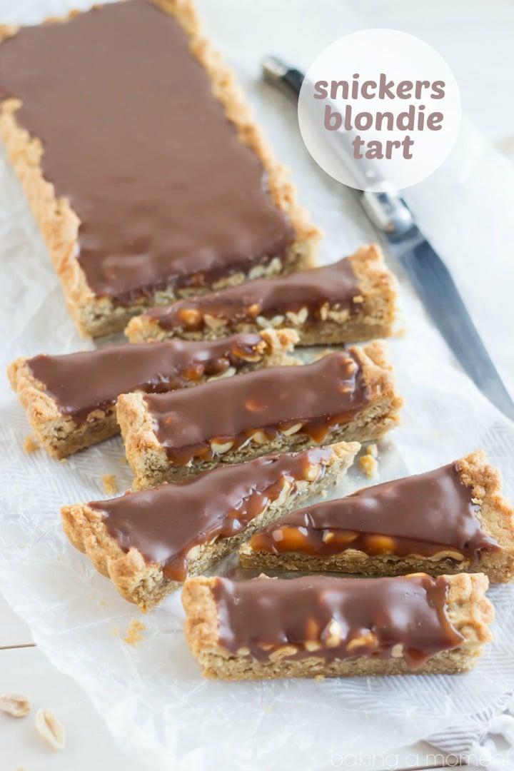 OMG! Snickers Blondie Tart- peanut butter blondie base filled with crunchy peanuts, salted caramel, and milk chocolate ganache! I just about died.