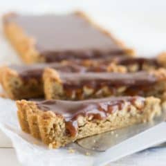 OMG! Snickers Blondie Tart- peanut butter blondie base filled with crunchy peanuts, salted caramel, and milk chocolate ganache! I just about died.