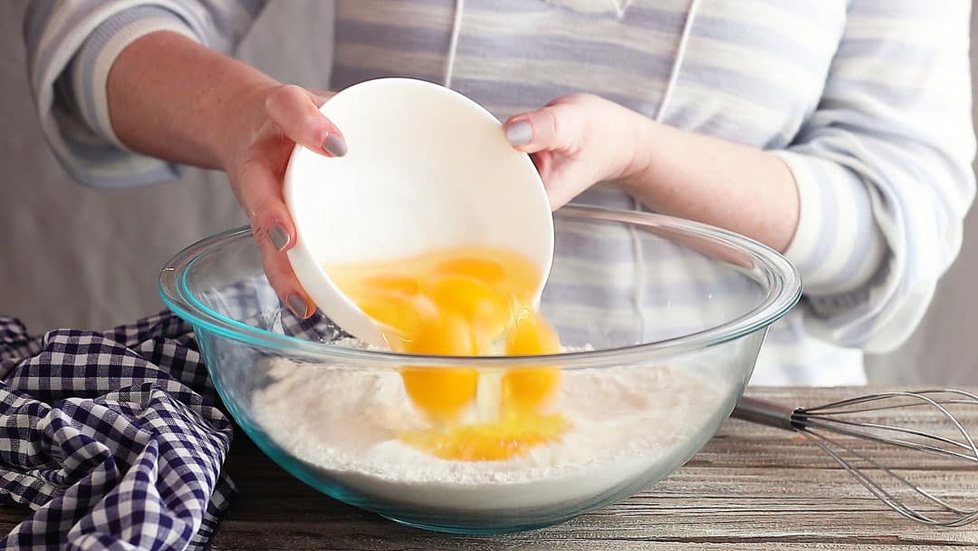 Adding eggs to lemon meringue pie filling.