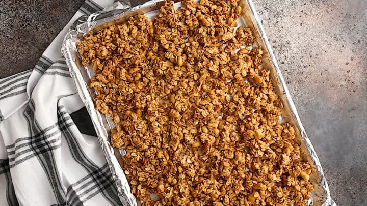 Unbaked granola, spread into an even layer on a baking sheet.