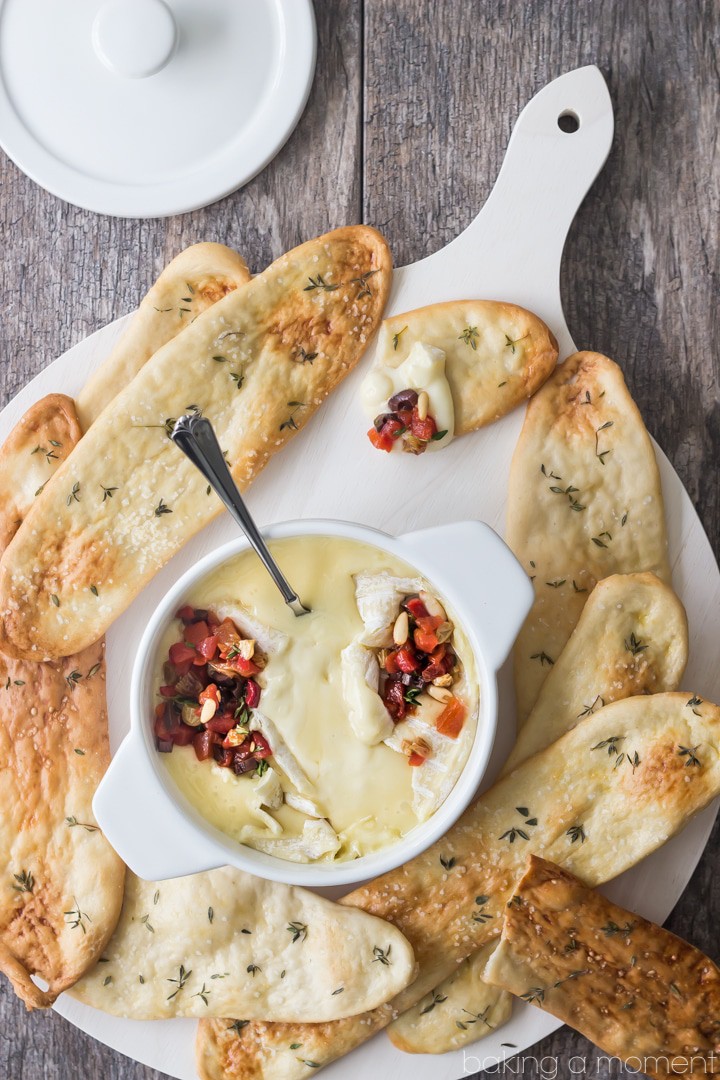 Serve this simple appetizer at your next get-together! The baked cheese is so creamy, and couldn't be easier to make, and the roasted red pepper relish has tons of smoky-sweet flavor! Scoop it all up with crunchy homemade herbed flatbreads. @marthastewart @macys #marthastewartcollection #mscollection