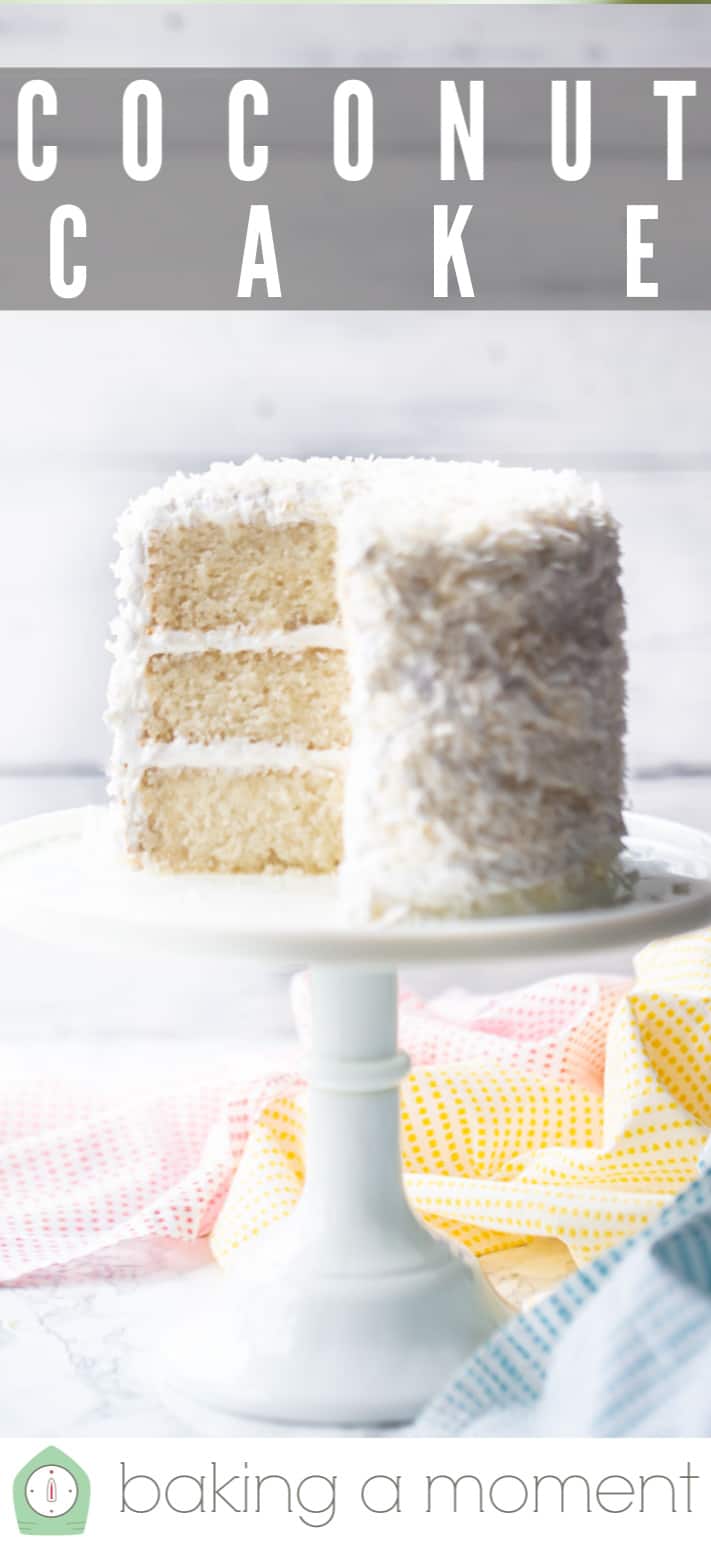 Coconut cake recipe served on a white pedestal with shredded coconut.