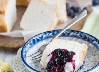 Classic Angel Food Cake: perfectly sweet & light as a cloud, served with fresh whipped cream and a citrus-y blueberry lemongrass topping.