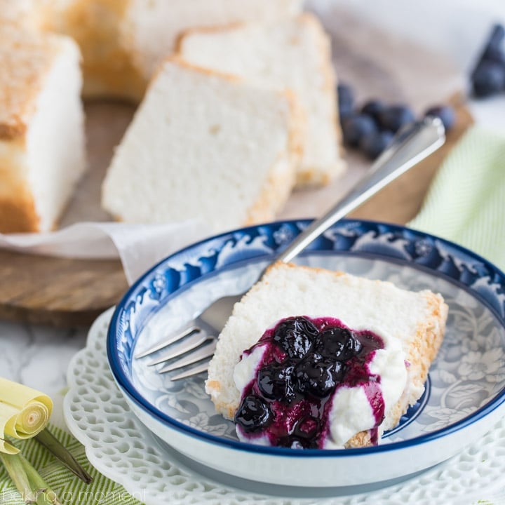 Classic Angel Food Cake: perfectly sweet & light as a cloud, served with fresh whipped cream and a citrus-y blueberry lemongrass topping.