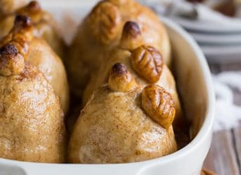 Soft baked pears encased in tender, buttery pastry, swimming in a sweet cinnamon sauce- these Pear Dumplings are fall comfort on a plate!