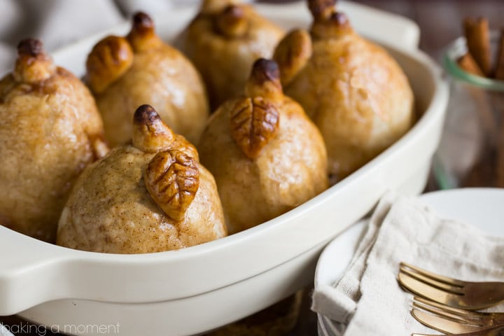 Soft baked pears encased in tender, buttery pastry, swimming in a sweet cinnamon sauce- these Pear Dumplings are fall comfort on a plate!