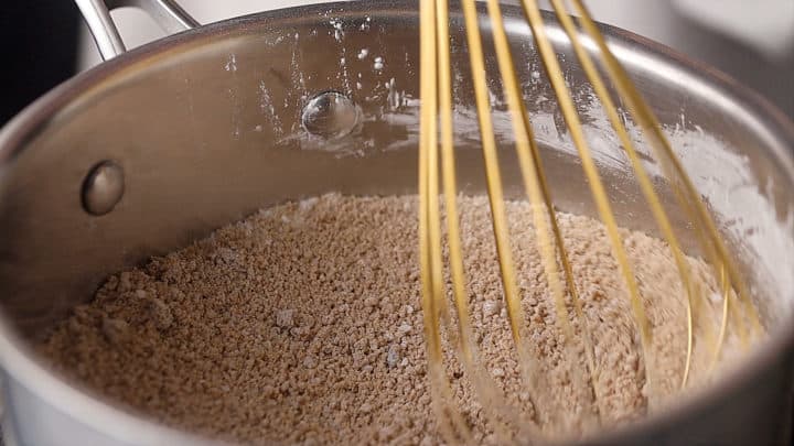 Mixing brown sugar, cornstarch, and salt together with a whisk.