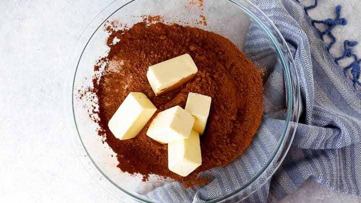 Sugar, cocoa powder, and butter in a large mixing bowl.