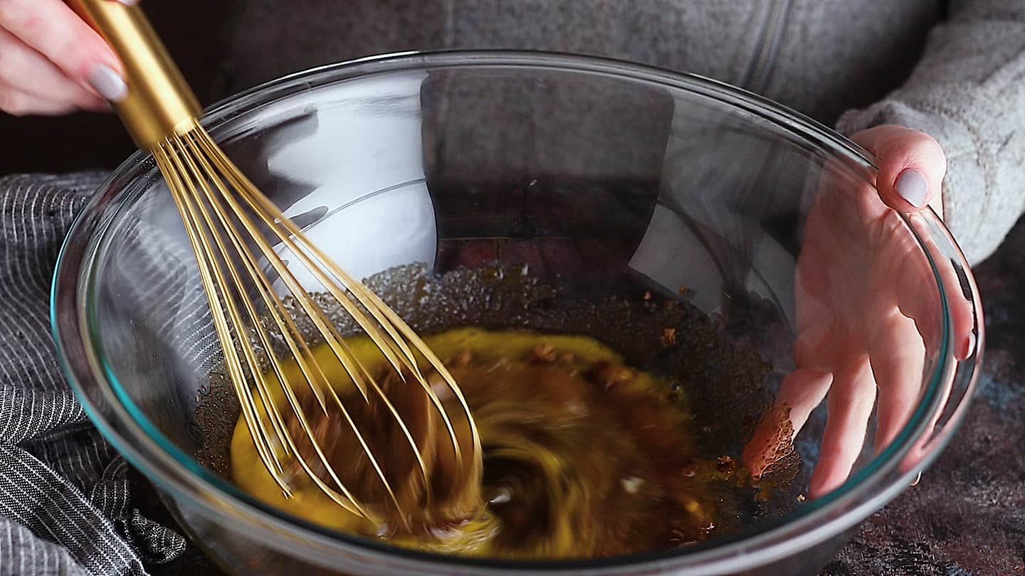 Whisking eggs and brown sugar together for chocolate pecan pie.