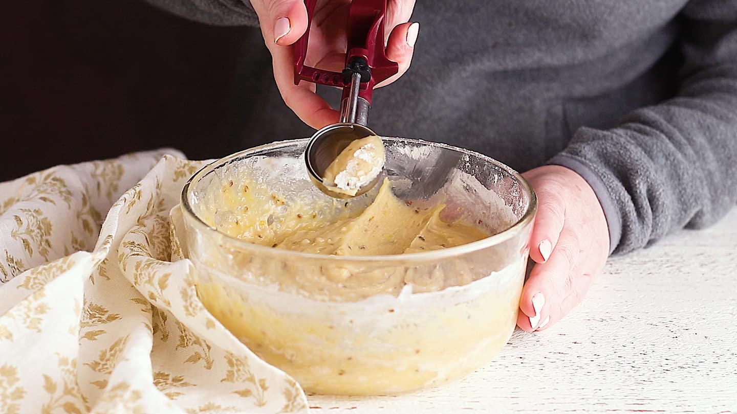 Scooping pizzelle dough with a cookie scoop.