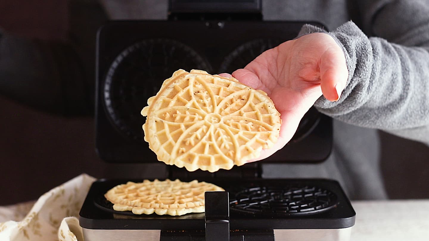 Making pizzelle recipe in a pizzelle maker.