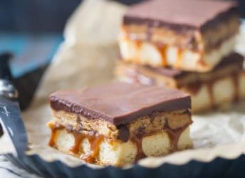 Peanut Butter Cookie Dough Billionaire Bars: OMG! These are so sinful- buttery shortbread with gooey caramel, edible peanut butter chocolate chip cookie dough, and a thick layer of chocolate ganache. Swoon!