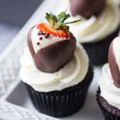 Tuxedo Cupcakes: moist, dark chocolate cake topped with rich ganache, fluffy whipped cream, and chocolate covered strawberries. These are so fun for a special occasion!
