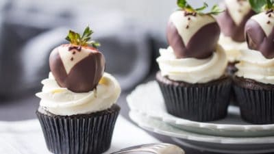 Tuxedo Cupcakes: moist, dark chocolate cake topped with rich ganache, fluffy whipped cream, and chocolate covered strawberries. These are so fun for a special occasion!