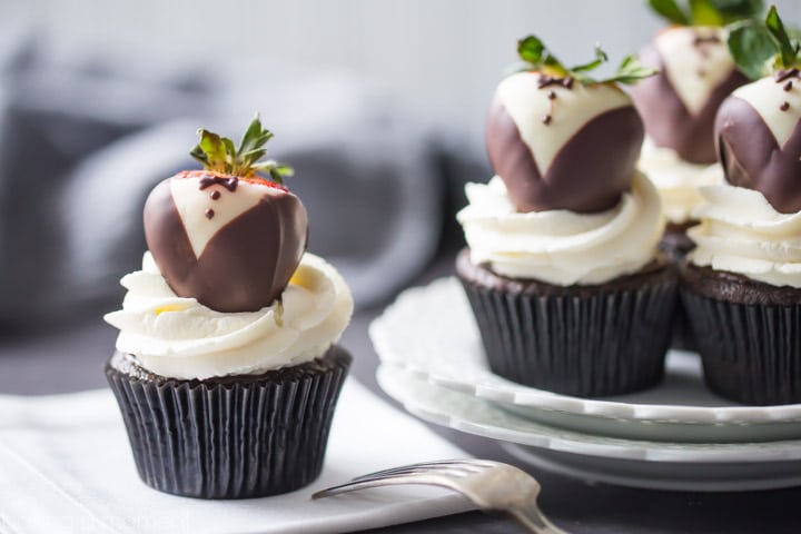 Tuxedo Cupcakes: moist, dark chocolate cake topped with rich ganache, fluffy whipped cream, and chocolate covered strawberries. These are so fun for a special occasion! food desserts cupcakes