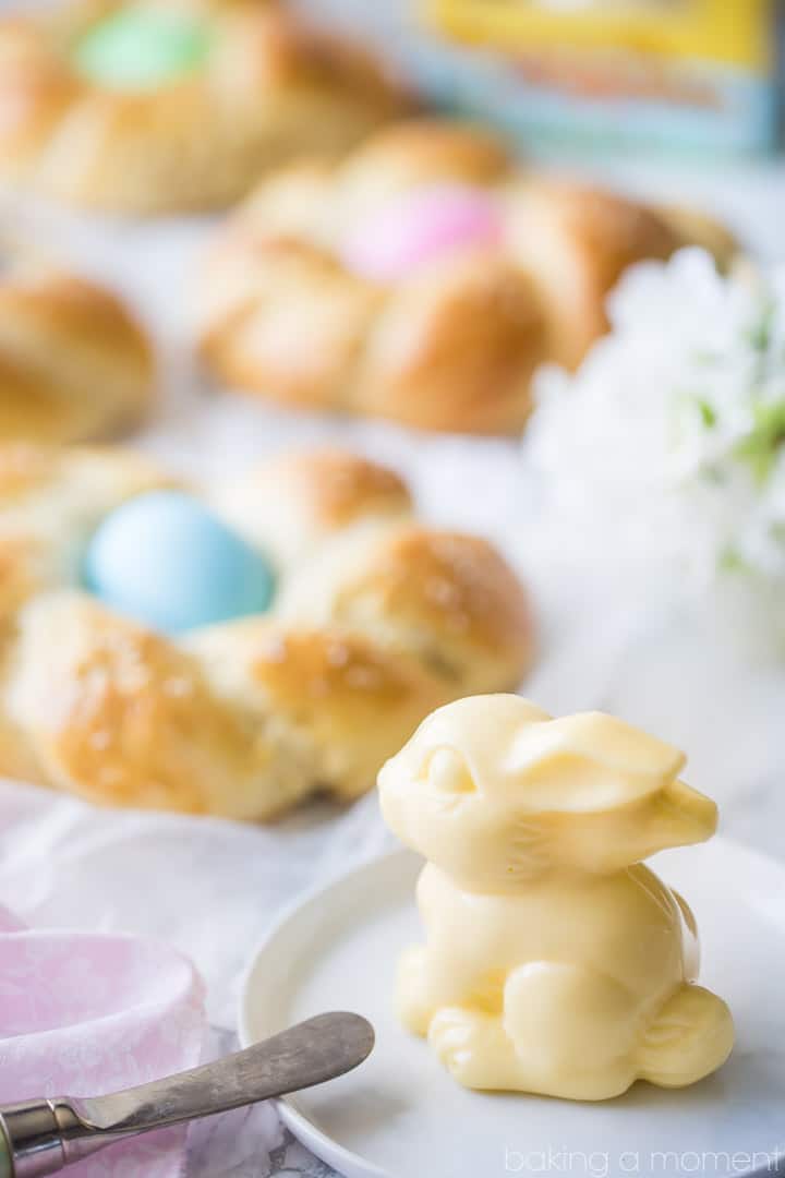 Easter Egg Bread: golden brown braided loaf with Easter eggs and a sweet butter sculpture in the shape of a bunny.