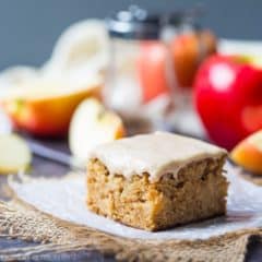 Maple Iced Apple Blondie on a napkin with apples in the background