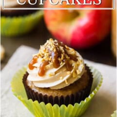 Caramel apple cupcake with caramel drizzle and chopped nuts in a green liner.