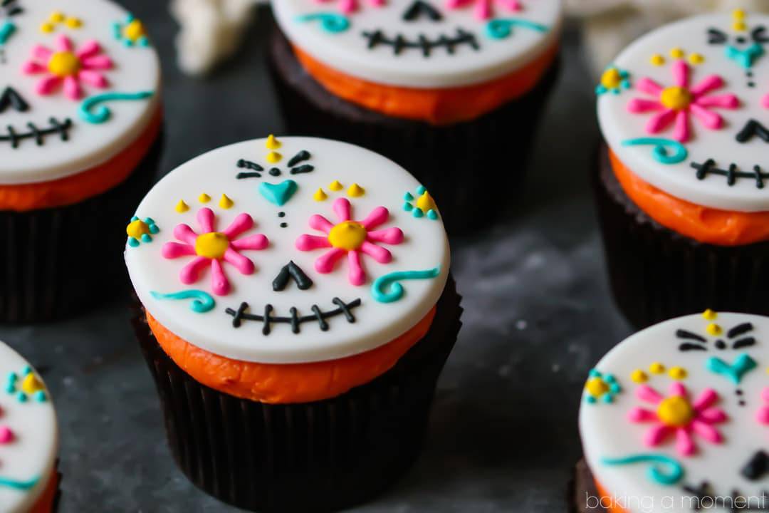 Day of the Dead Cupcakes- colorful fondant topper on a dark chocolate cupcake with bright orange frosting.