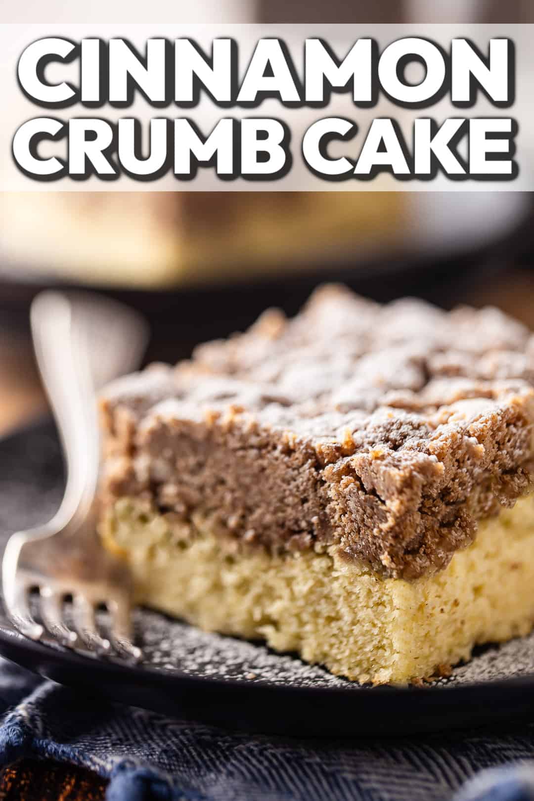 Crumb cake recipe, made with double the streusel topping, presented on a plate and dusted with powdered sugar.