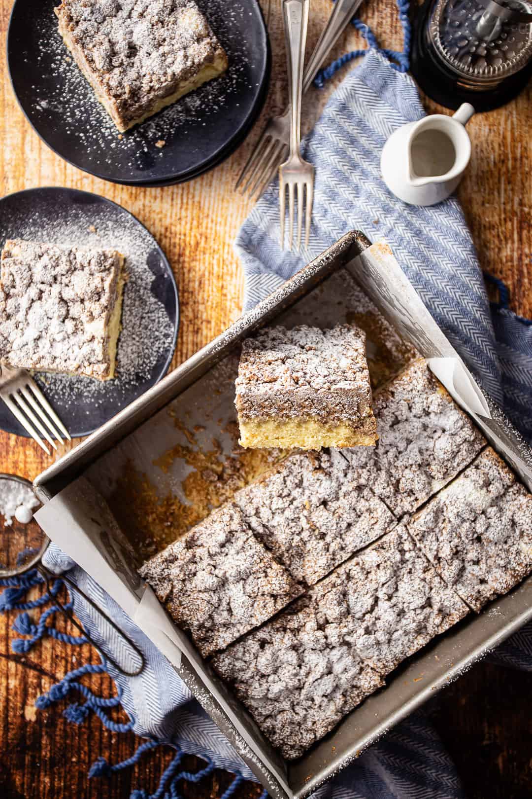 Cinnamon crumb cake, baked in a square pan and cut into bars.