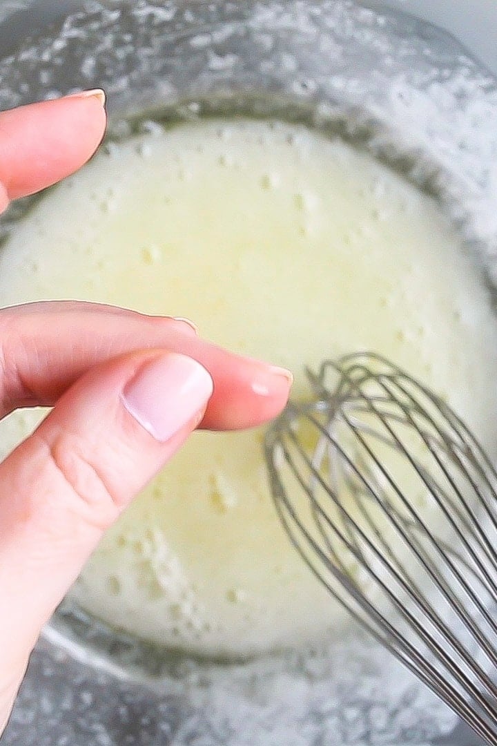 Swiss Meringue Buttercream: Rubbing a small amount of cooked egg white & sugar between the thumb and forefinger.