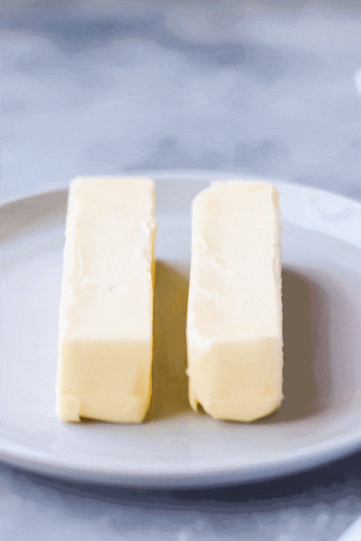 Swiss Meringue Buttercream: animated gif of softened butter being pressed with a forefinger.