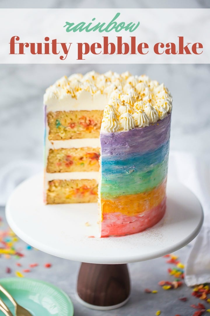 Rainbow fruity pebble cake on a stand with text overlay.
