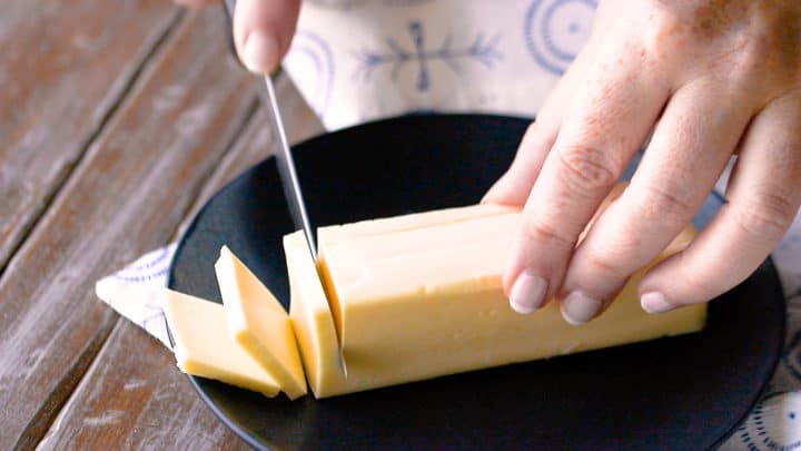 Cutting butter into thin slices for homemade pie crust.