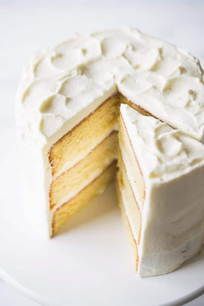 Interior view of vanilla cake, displaying the moist layers and filling in between.