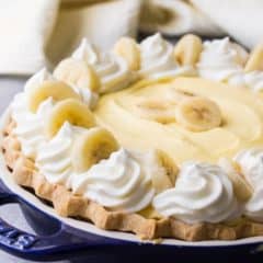 Banana Cream Pie with fluffy custard, swirls of whipped cream, and fresh bananas.