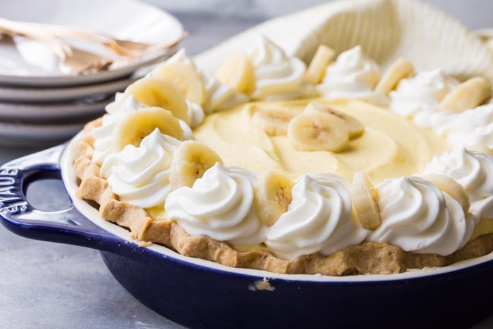 Banana Cream Pie with fluffy diplomat cream filling, real bananas, and sweet whipped cream, nestled into a flaky homemade pie crust.