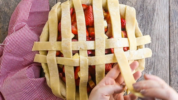 How to Make Lattice Pie Crust Step-by-Step: Weaving second horizontal strip.