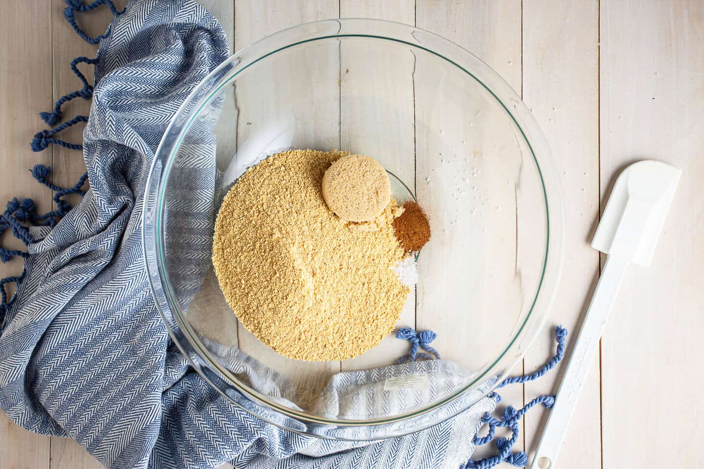 Graham cracker crumbs, brown sugar, cinnamon, and salt in a large glass mixing bowl.