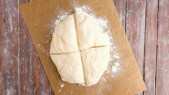 Easy French baguette recipe dough divided into 4 equal portions.