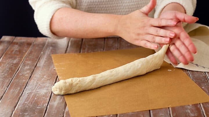 Shaping easy French baguette recipe loaf.