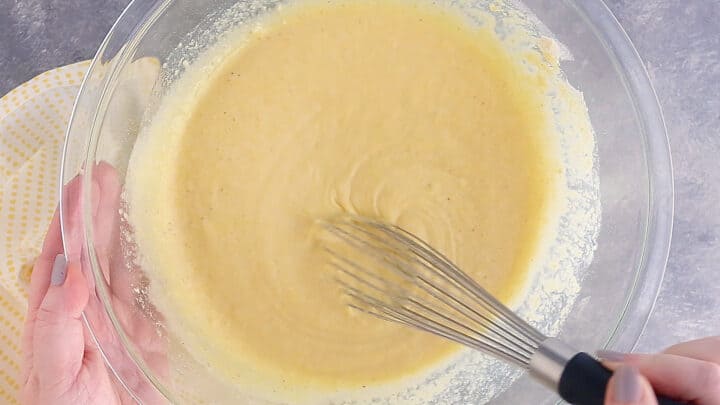 Whisking cornbread batter together until smooth.