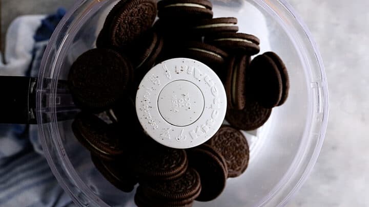 Oreo cookies in the bowl of a food processor.