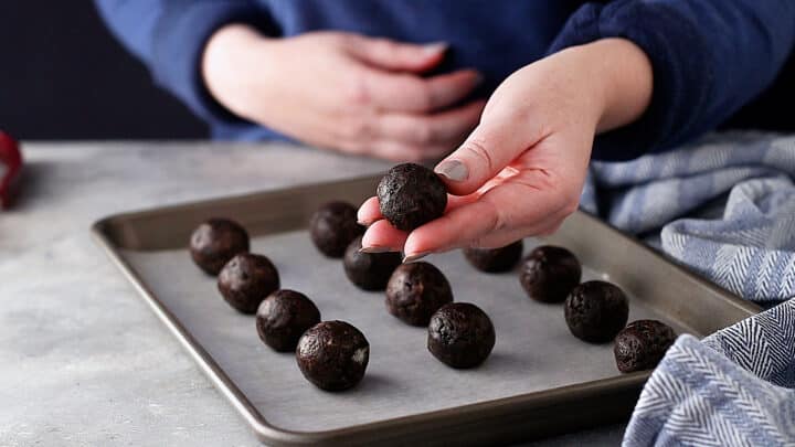 Rolling truffle filling into Oreo balls.