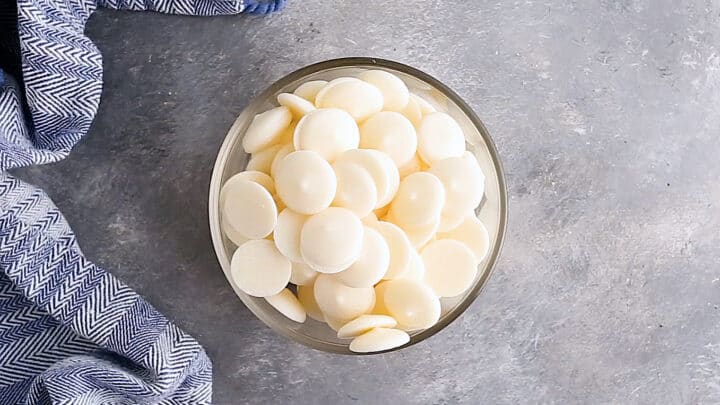 White candy melts in a medium glass bowl.