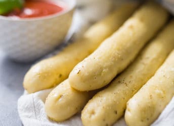 Bundle of bread sticks wrapped in a napkin.