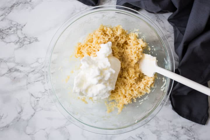 Bowl of coconut, condensed milk, and stiffly whipped egg whites for macaroons.