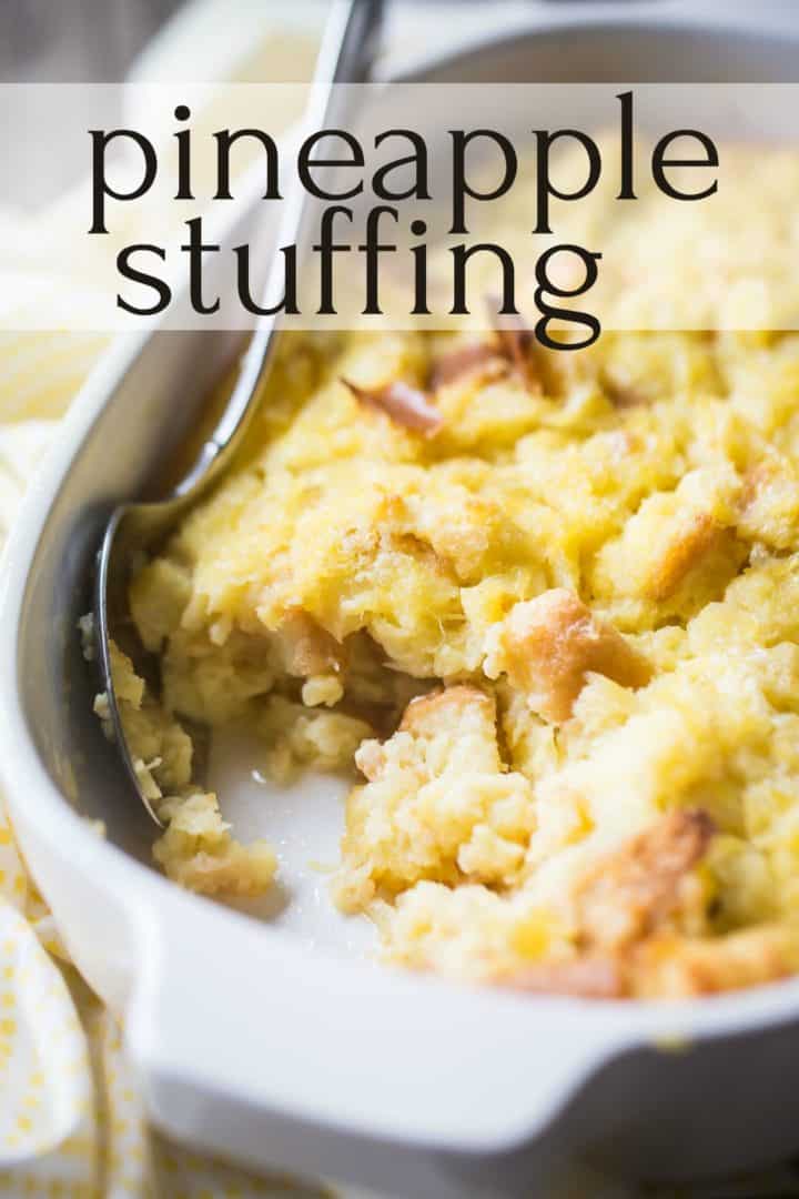 Pineapple stuffing in a white casserole dish with a serving scooped out.