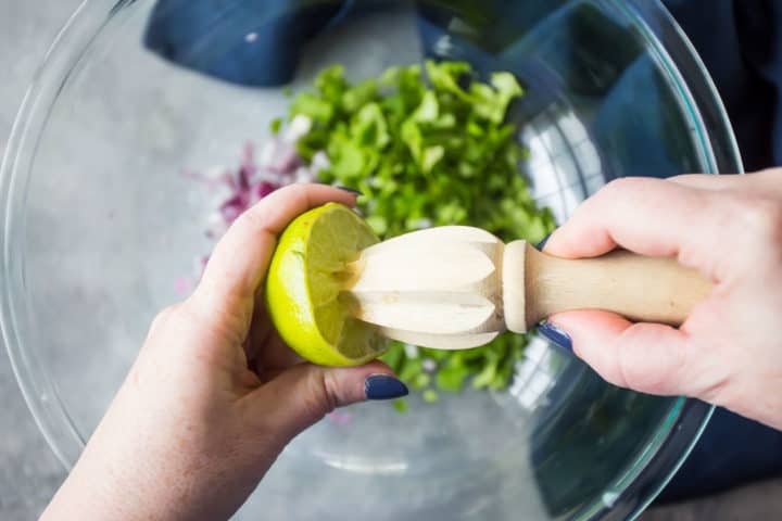 Juicing a lime with a citrus reamer.